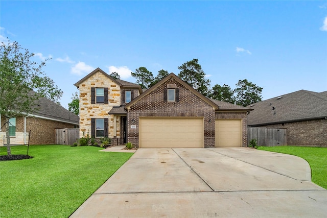 traditional home with fence, an attached garage, concrete driveway, and a front yard