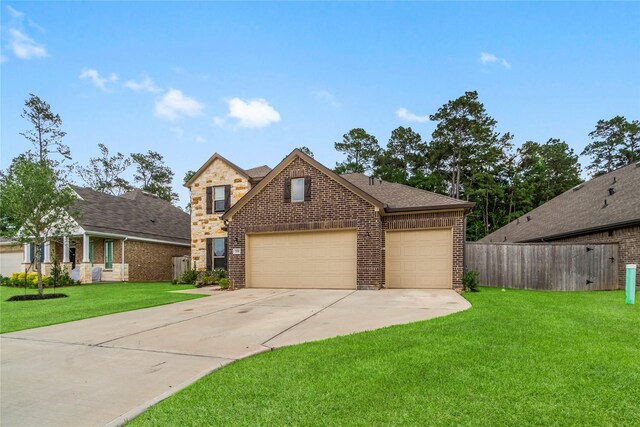 traditional home with brick siding, an attached garage, driveway, and fence