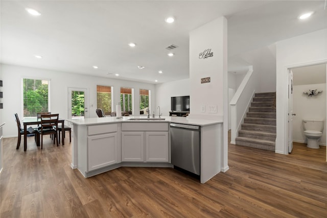 kitchen featuring a sink, stainless steel dishwasher, dark wood-style floors, and visible vents