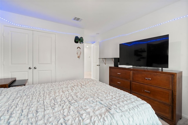 bedroom with a closet and visible vents