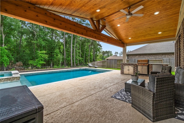 view of pool featuring a patio, a fenced backyard, a ceiling fan, exterior kitchen, and a pool with connected hot tub