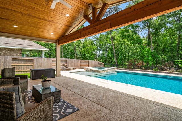 view of pool with a fenced backyard, ceiling fan, a pool with connected hot tub, and a patio area