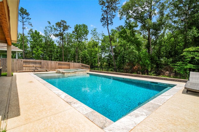 view of pool featuring a fenced backyard, a patio area, and a pool with connected hot tub