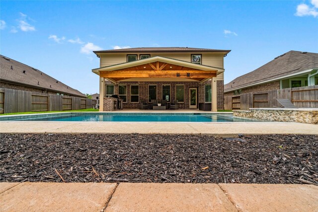 outdoor pool with a fenced backyard, an outdoor hangout area, and a patio area