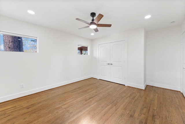 unfurnished room with a ceiling fan, baseboards, recessed lighting, and wood finished floors