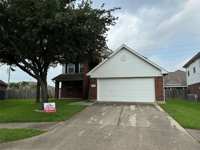 view of front facade featuring central AC unit, a garage, brick siding, fence, and a front lawn