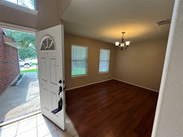 16407 Thyme Green Ln, Cypress, TX 77433 - foyer entrance with a chandelier, healthy amount of natural light, and wood finished floors