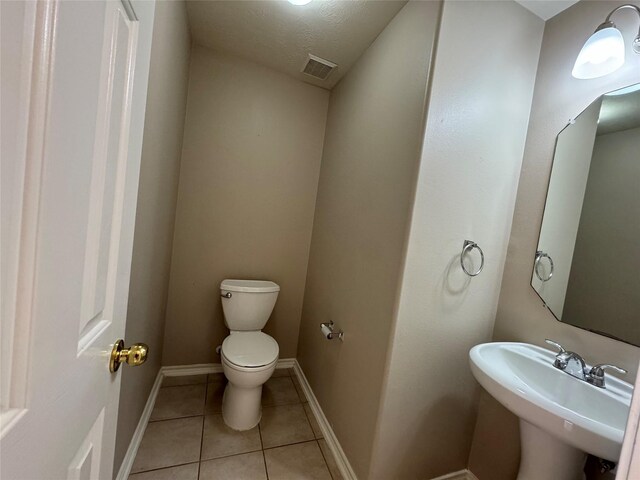 16407 Thyme Green Ln, Cypress, TX 77433 - half bath featuring toilet, tile patterned floors, a sink, and baseboards