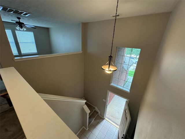 stairs with tile patterned floors, visible vents, and a wealth of natural light
