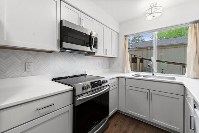 kitchen featuring a sink, decorative backsplash, appliances with stainless steel finishes, and light countertops