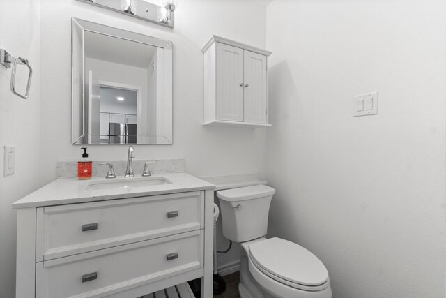 bathroom featuring toilet and vanity