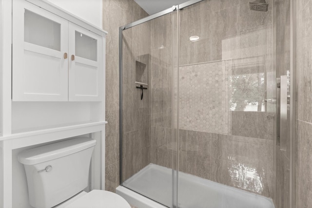 full bath with a stall shower and toilet