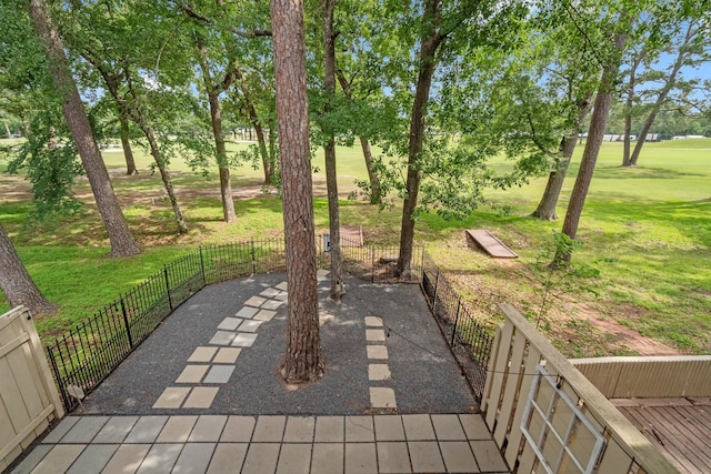 view of patio / terrace featuring fence and view of golf course