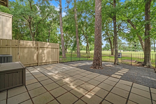 view of patio / terrace featuring fence and cooling unit