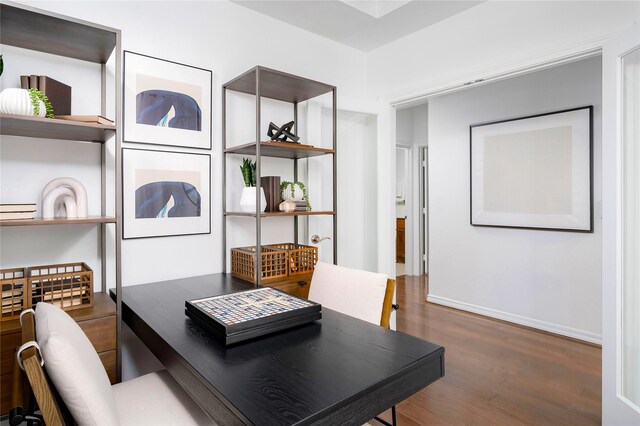 dining area with baseboards and wood finished floors