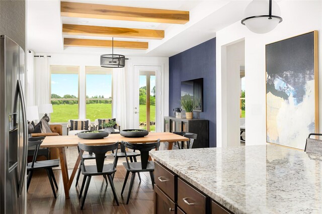 dining area featuring plenty of natural light, dark wood finished floors, and beam ceiling