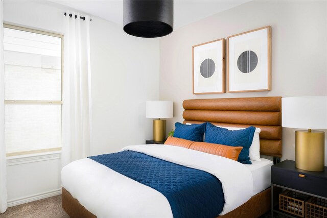 bedroom featuring carpet floors and baseboards