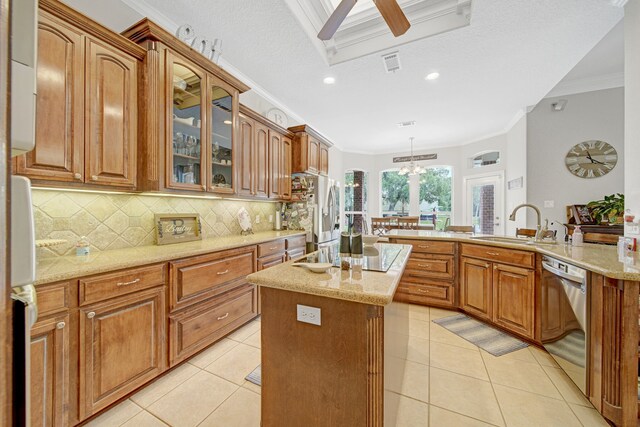 kitchen featuring backsplash, crown molding, a center island, a sink, and stainless steel appliances