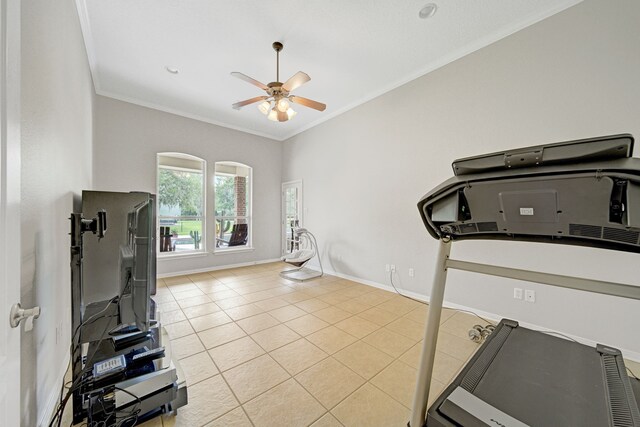 workout area featuring tile patterned floors, ornamental molding, baseboards, and a ceiling fan