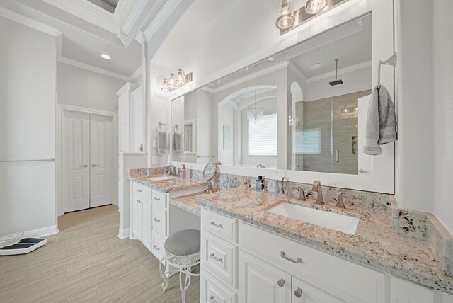 bathroom featuring vanity, ornamental molding, a stall shower, and recessed lighting