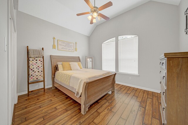 bedroom featuring baseboards, ceiling fan, light wood finished floors, and lofted ceiling