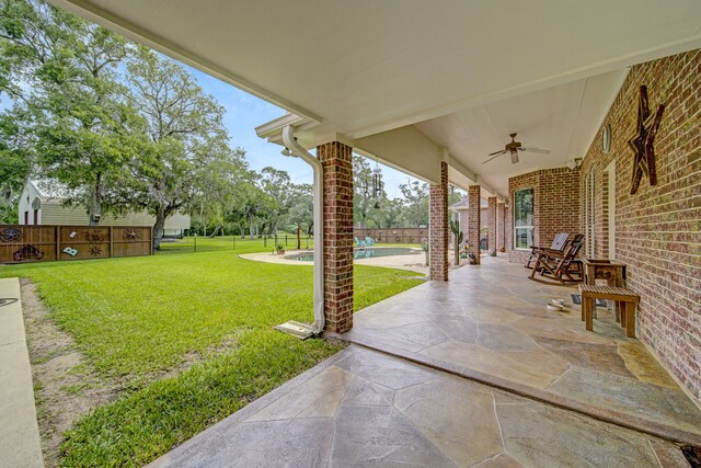view of patio / terrace with a fenced in pool, a fenced backyard, and ceiling fan