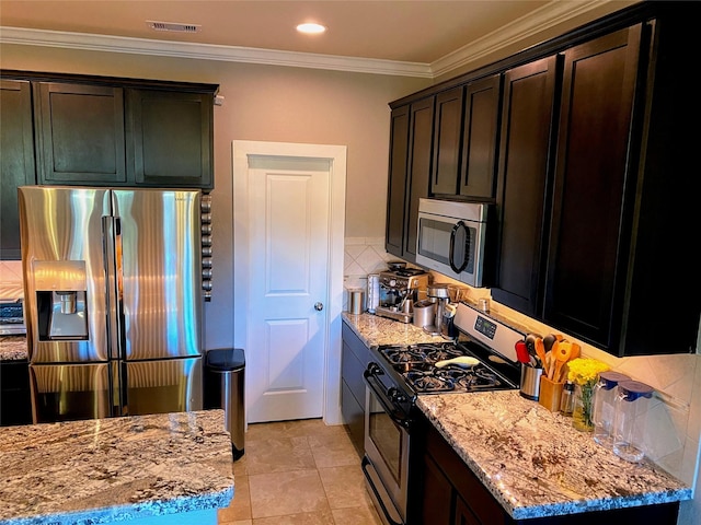 kitchen with visible vents, decorative backsplash, ornamental molding, light stone countertops, and stainless steel appliances