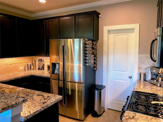 kitchen featuring crown molding, appliances with stainless steel finishes, and light stone counters