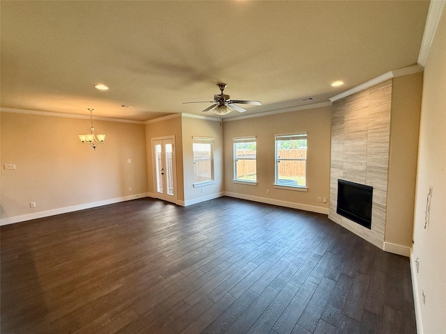 unfurnished living room with crown molding, baseboards, a tiled fireplace, dark wood finished floors, and ceiling fan with notable chandelier
