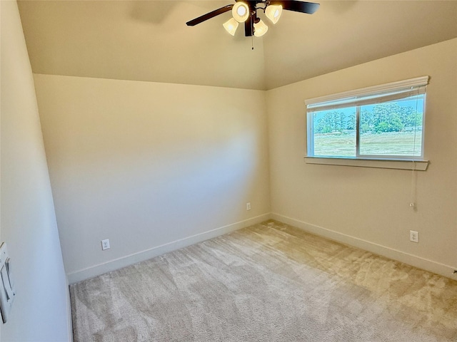 empty room featuring baseboards, a ceiling fan, carpet flooring, and lofted ceiling