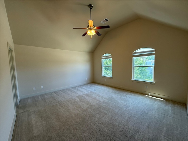 additional living space featuring carpet floors, ceiling fan, vaulted ceiling, and visible vents