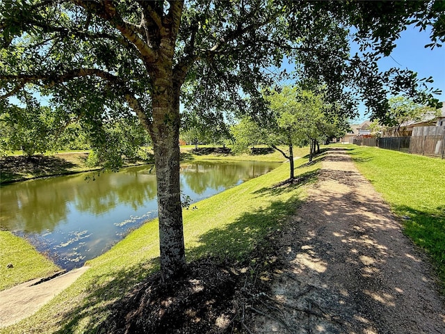 property view of water featuring fence