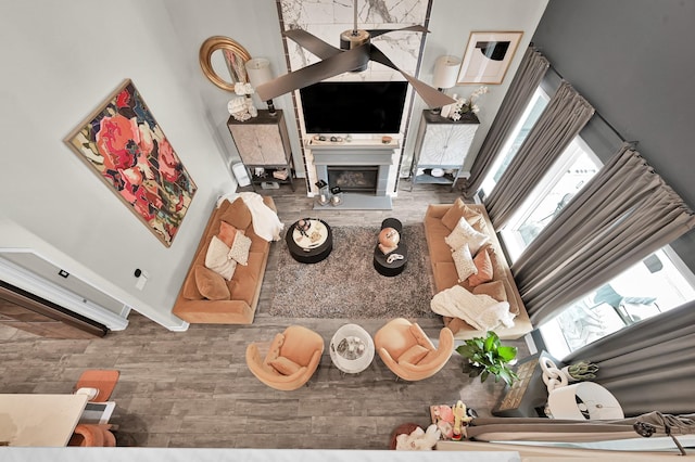 living room featuring wood finished floors and a large fireplace