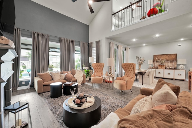 living room featuring high vaulted ceiling, a ceiling fan, and wood finished floors