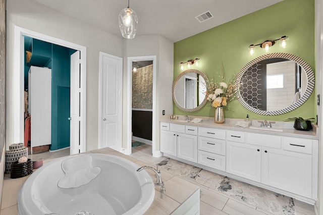 full bath with double vanity, visible vents, a sink, and a bath