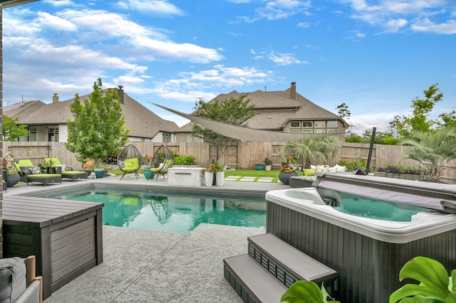 view of pool with a hot tub, a fenced in pool, a fenced backyard, and a patio area