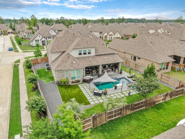 exterior space with a residential view, a fenced in pool, a fenced backyard, a yard, and a patio