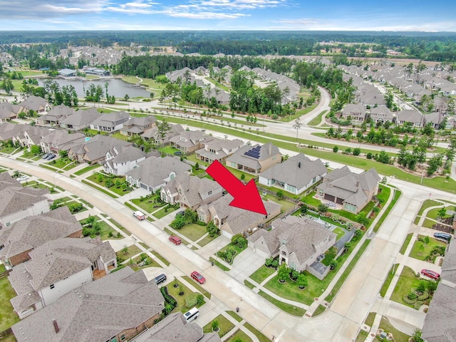 drone / aerial view featuring a residential view and a water view