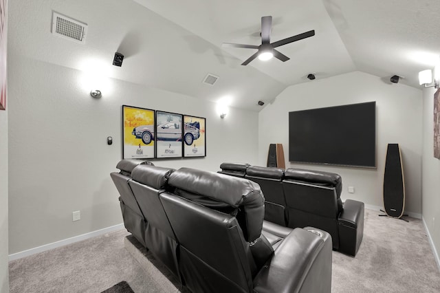 cinema featuring vaulted ceiling, light colored carpet, and visible vents