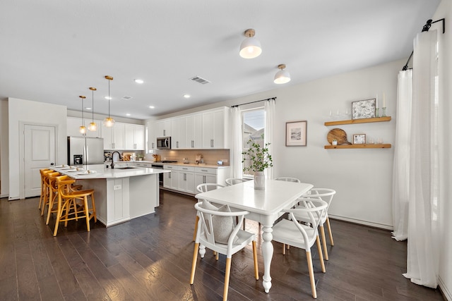 dining space with dark wood-style flooring, visible vents, and recessed lighting