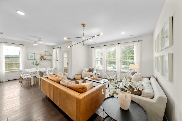 living room with dark wood-style flooring, a chandelier, recessed lighting, and visible vents