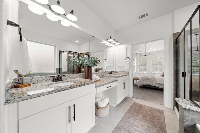 bathroom featuring visible vents, an inviting chandelier, tile patterned floors, a shower stall, and ensuite bath