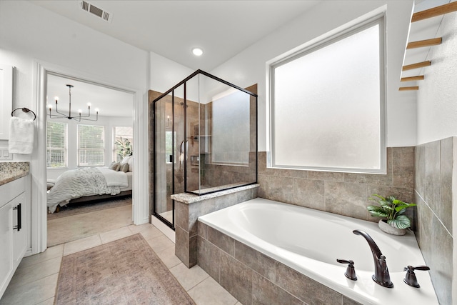 ensuite bathroom featuring visible vents, a garden tub, tile patterned flooring, vanity, and a stall shower