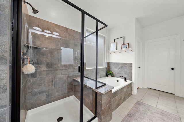 full bathroom with tile patterned floors, a stall shower, and a bath