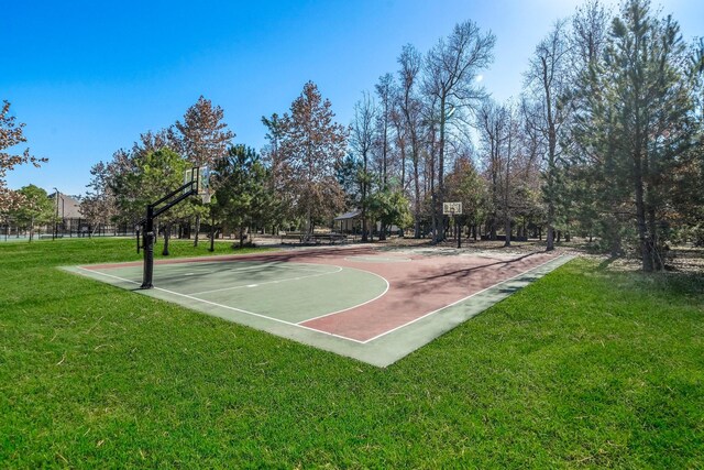 view of basketball court featuring a lawn and community basketball court