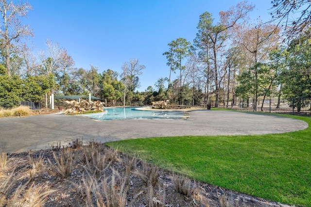 view of swimming pool featuring a fenced in pool, a patio area, fence, and a yard