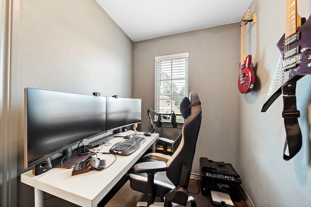 home office featuring baseboards and wood finished floors