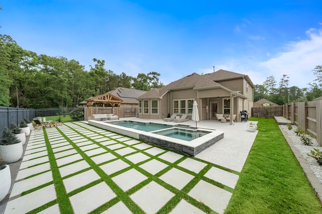 back of house featuring a gazebo, a fenced in pool, a fenced backyard, an in ground hot tub, and a patio area