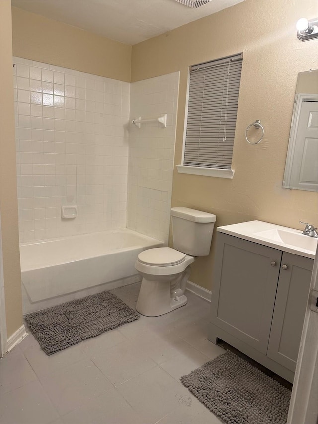 bathroom with tile patterned flooring, vanity, toilet, baseboards, and tub / shower combination