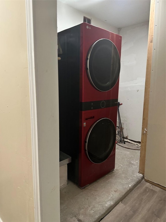 laundry room with stacked washer and clothes dryer and laundry area